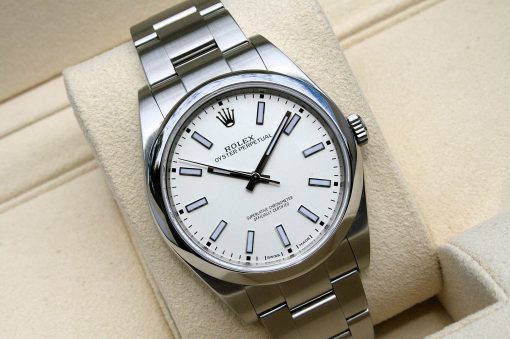 IMG_6978 | SD Watches Close-up of a stainless steel Rolex Oyster Perpetual wristwatch on a beige surface.