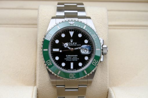 IMG_7086 | SD Watches Rolex Submariner stainless steel watch with a black dial and green bezel on a beige display cushion.