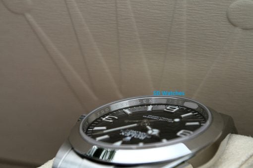 IMG_7094 | SD Watches Close-up of a metallic Rolex watch face with visible hour markers and bezel, partial view shows a blue SD Watches watermark.