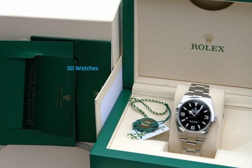 IMG_7099 | SD Watches Rolex watch displayed in a beige interior box with a green exterior and accompanying tags/guarantee cards