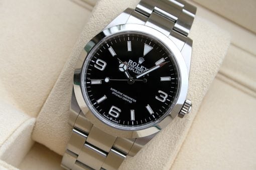 IMG_7104 | SD Watches Close-up of a stainless steel Rolex Explorer watch with a black dial on a beige cushion.