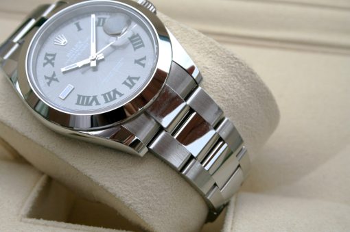 IMG_7124 | SD Watches Close-up of a silver Rolex wristwatch with Roman numerals, resting on a beige velvet display.
