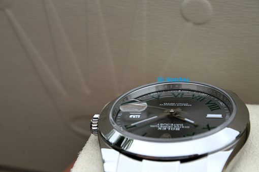 IMG_7129 | SD Watches Close-up of a stainless steel wristwatch with a black dial and Roman numerals resting on a beige surface. A blue 'SD Watches' watermark is visible.