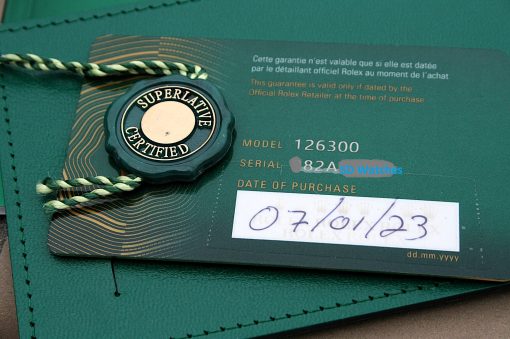 IMG_7131 | SD Watches Green Rolex tag reading 'Superlative Certified' attached to a green leather certificate card with braided string.