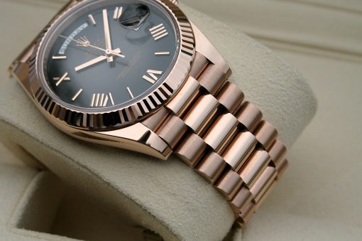 IMG_7144 | SD Watches Close-up of a rose-gold Rolex watch with a fluted bezel and metal link bracelet on a soft beige surface.