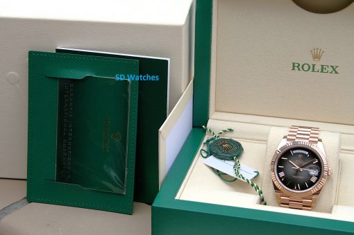 IMG_7153 | SD Watches Rolex watch in an open beige presentation box with a green outer case and accompanying papers and tag
