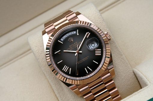 IMG_7154 | SD Watches Rose gold Rolex Day-Date watch with a black dial and day window, resting on a beige cushion.