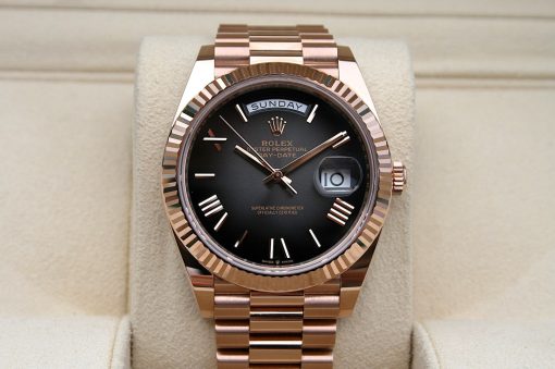 IMG_7156 | SD Watches Rose gold Rolex Day-Date wristwatch with black dial and date window showing 10, resting on a beige cushion