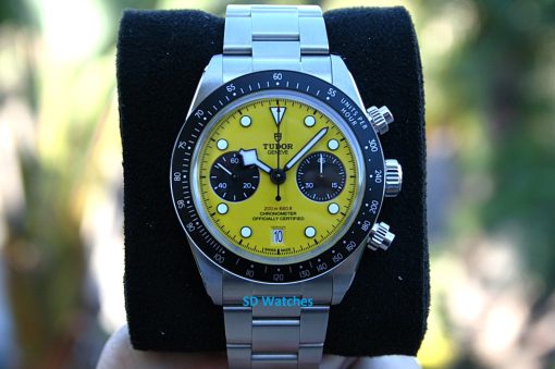 Tudor 79310N | SD Watches Tudor Genève chronograph with a bright yellow dial, black subdials, and a stainless steel bracelet on a black display cushion.