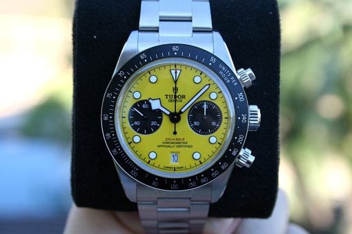IMG_7203 | SD Watches Close-up of a Tudor wristwatch with a bright yellow dial, silver bezel, and metal bracelet showing two black subdials.