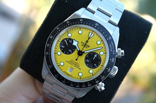 IMG_7204 | SD Watches Close-up of a Tudor chronograph watch with a bright yellow dial, black subdials, and a stainless steel bracelet.