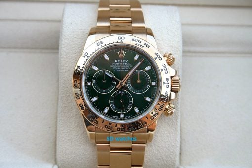 Rolex 116508 | SD Watches Gold Rolex Daytona chronograph with a green dial and tachymeter bezel on a beige display cushion