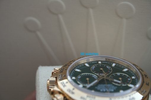 IMG_7213 | SD Watches Close-up of a gold-tone wristwatch with a green dial and textured bezel, featuring a blue 'SD watches' watermark.