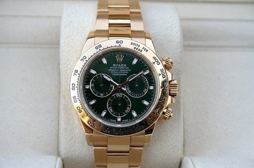 IMG_7224 | SD Watches Gold Rolex Oyster Perpetual Cosmograph chronograph with green dial on a light display cushion.