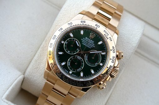 IMG_7226 | SD Watches Gold Rolex watch with green dial resting on a beige cushion, close-up detail of the bracelet and bezel
