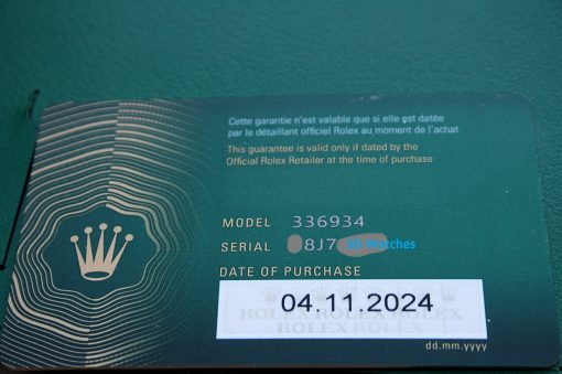 IMG_7239 | SD Watches Green Rolex warranty card showing model and purchase date, with crown logo and embossed lines near the left edge