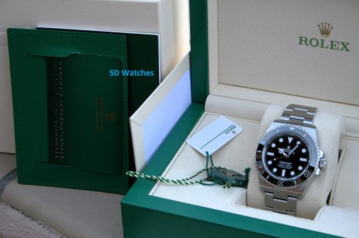 IMG_7255 | SD Watches Rolex Submariner watch in a beige box with a green exterior and tags visible nearby.