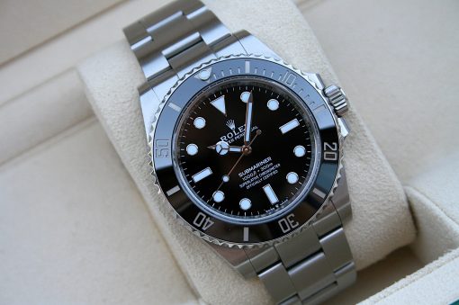 IMG_7256 | SD Watches Close-up of a silver Rolex Submariner watch with a black dial and rotating bezel on a metal bracelet