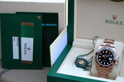 IMG_7275 | SD Watches Rolex watch in an open beige presentation box with a green outer case and a green wallet with cards nearby on the left edge.