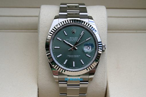 Rolex 126334 | SD Watches Rolex Oyster Perpetual Datejust with green dial and fluted bezel on a beige display cushion, stainless steel bracelet