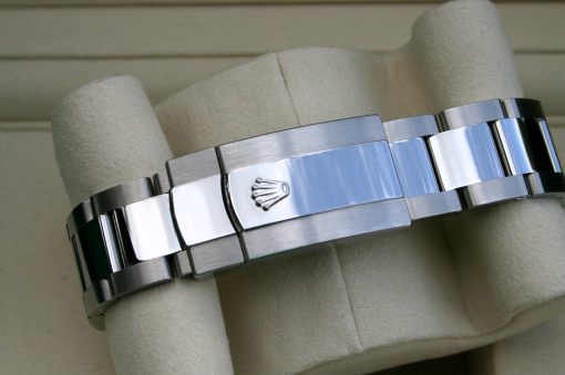 IMG_7290 | SD Watches Close-up of a stainless steel Rolex watch bracelet, featuring the Rolex crown on the clasp center.