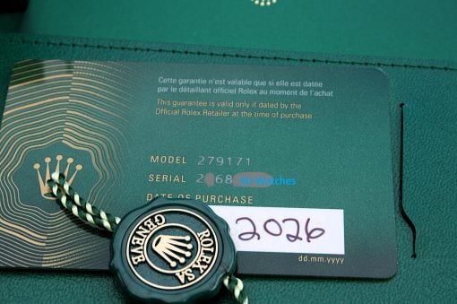 IMG_7310 | SD Watches Green Rolex warranty card with crown emblem, model 279171, and a braided green-and-white cord.