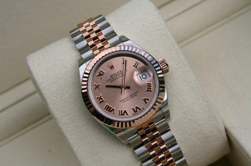 IMG_7312 | SD Watches Rose-gold Rolex wristwatch with two-tone band on a beige cushion, pink dial and Roman numerals, date window at 3 o'clock with magnifier