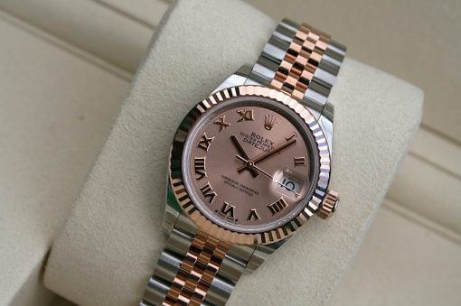 IMG_7317 | SD Watches Two-tone Rolex Datejust wristwatch with a pink dial on a beige display cushion, featuring a fluted bezel and Roman numeral markers.