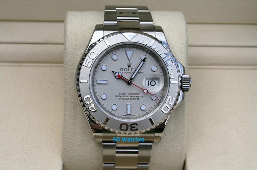 Rolex 116622 | SD Watches Close-up of a silver Rolex Yacht-Master watch on a beige display cushion, with a date window at 3 o'clock and a white dial.