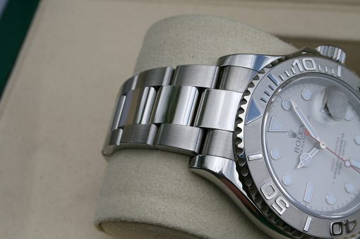 IMG_7323 | SD Watches Close-up of a stainless steel Rolex watch showing the brushed bracelet links and ridged bezel on a light surface.