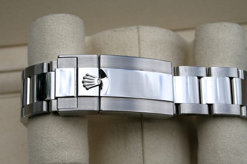 IMG_7324 | SD Watches Close-up of a stainless steel Rolex Oyster bracelet with folding clasp and crown logo emblem on the clasp surface, highlighting brushed and polished links.