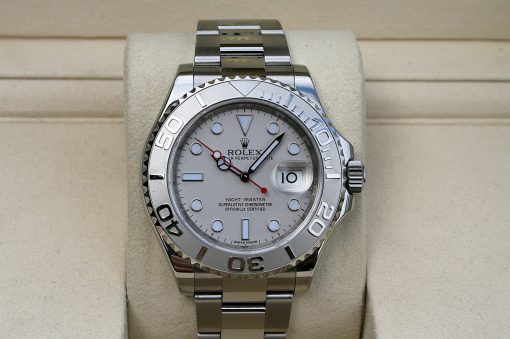 IMG_7335 | SD Watches Close-up of a stainless steel Rolex Yacht-Master watch on a beige display cushion; silver dial, rotating bezel, date window at 3 o'clock.