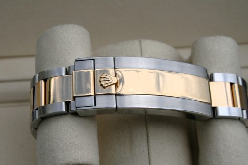 IMG_7343 | SD Watches Close-up of a two-tone Rolex watch bracelet with gold center links and the crown clasp in focus.