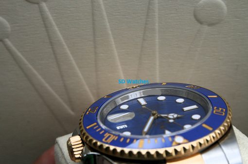 IMG_7344 | SD Watches Close-up of a blue Rolex dive watch with a gold bezel and white hour markers, watermark 'SD Watches' across the image.