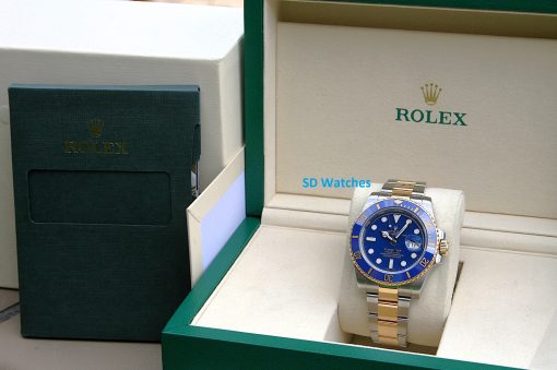 IMG_7349 | SD Watches Rolex watch with blue dial in an open beige and green display box; ROLEX logo on the inner lid visible