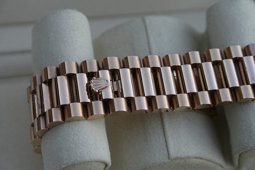 IMG_7359 | SD Watches Close-up of a two-tone metal Rolex-style watch bracelet with a Rolex crown logo on the clasp area.