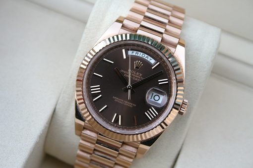 IMG_7371 | SD Watches Rose gold Rolex Day-Date wristwatch with a black dial, fluted bezel, and date window at 3 o'clock on a light cushion.
