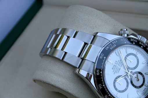 IMG_7376 | SD Watches Close-up of a stainless steel Rolex watch with a black bezel, resting on a light cushion.
