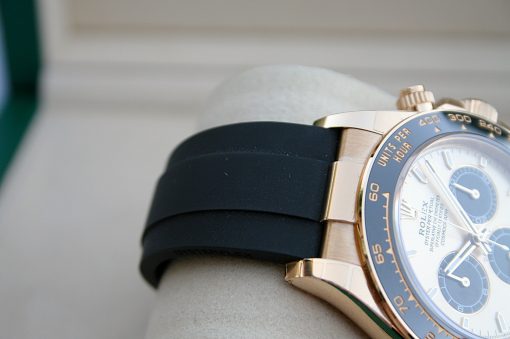 IMG_7392 | SD Watches Close-up of a gold Rolex watch with a black rubber strap on a wrist.
