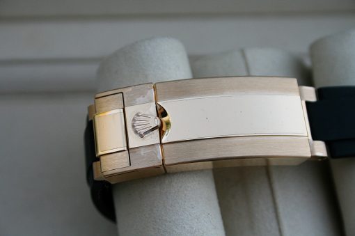 IMG_7393 | SD Watches Close-up of a gold-tone metal watch bracelet clasp with the Rolex crown logo visible on the clasp body.