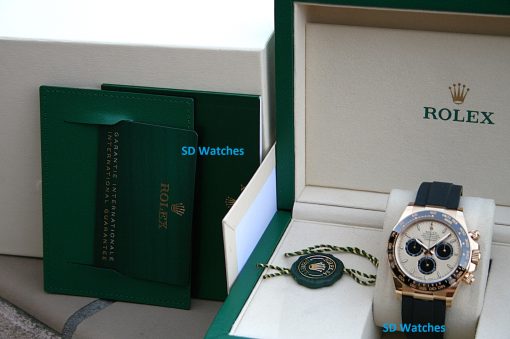 IMG_7401 | SD Watches Rolex watch in an open green and cream presentation box with a green warranty card nearby and a blue SD Watches watermark.