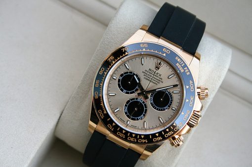 IMG_7407 | SD Watches Close-up of a gold Rolex watch with a blue bezel and black strap on a light background.