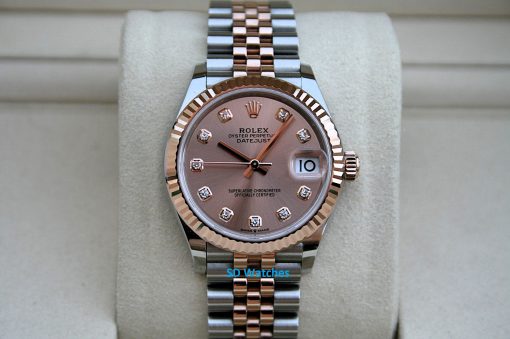Rolex 278271 Midsize | SD Watches Two-tone Rolex Datejust wristwatch with diamond hour markers on a pink dial, displayed on a beige cushion.