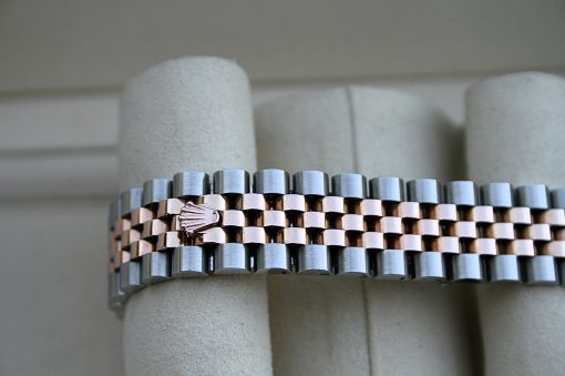 IMG_7414 | SD Watches Close-up of a two-tone metal watch band with interlocking links and a Rolex crown emblem on one link
