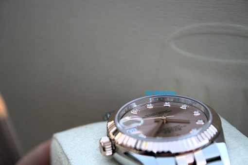 IMG_7418 | SD Watches Close-up of a stainless steel wristwatch resting on a light surface, with the blue text 'SD Watches' watermark over the dial.