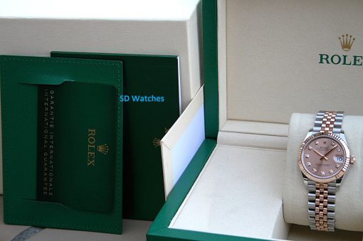 IMG_7423 | SD Watches Rolex watch in a beige display box with green trim and branding visible on the box and case outline.