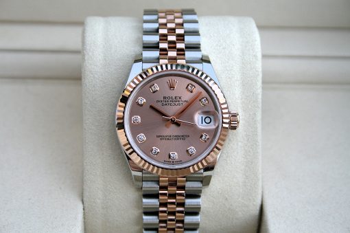 IMG_7426 | SD Watches Rose-gold and silver Rolex watch with diamond hour markers, fluted bezel, and date window magnifier on a light display stand