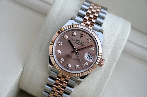 IMG_7429 | SD Watches Two-tone Rolex Datejust wristwatch with rose dial, diamond hour markers, fluted bezel, and Jubilee bracelet on a beige display cushion.