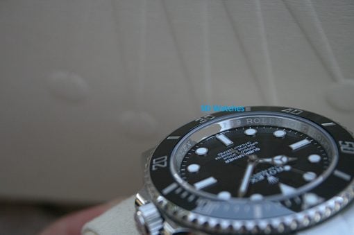 IMG_7438 | SD Watches Close-up of a black Rolex dive watch with a silver bezel, partially visible in the frame, against a muted background.