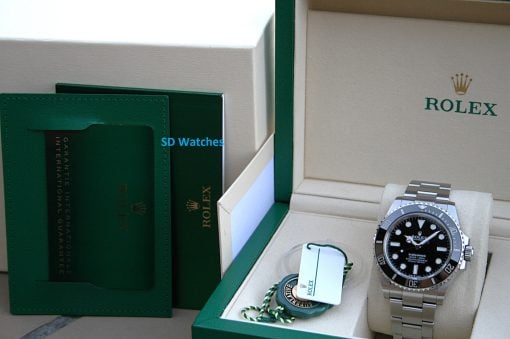 IMG_7440 | SD Watches Rolex Submariner watch in beige box with green outer packaging and accompanying tags.